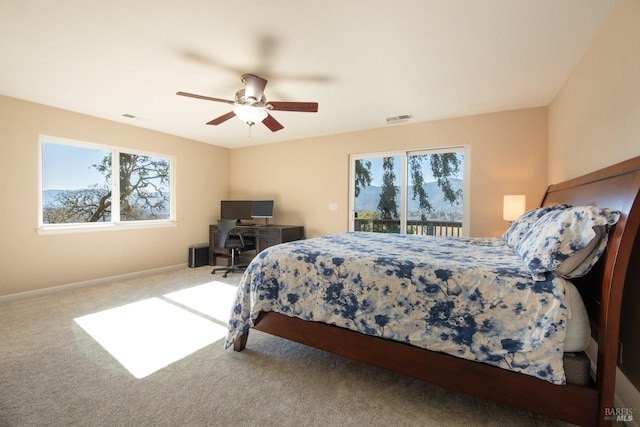 bedroom featuring access to outside, ceiling fan, and carpet