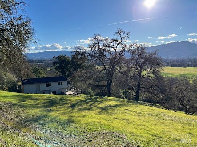 drone / aerial view featuring a mountain view and a rural view