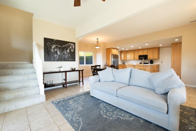 tiled living room with ceiling fan