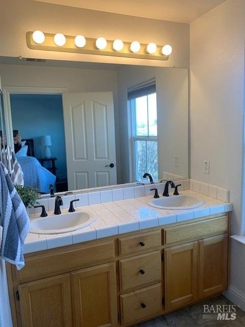 bathroom featuring tile patterned flooring and vanity