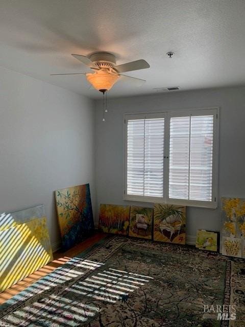 bedroom featuring ceiling fan and multiple windows