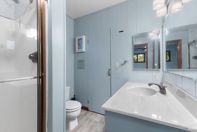 bathroom featuring hardwood / wood-style flooring, toilet, and vanity