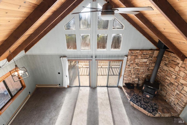 unfurnished living room featuring ceiling fan with notable chandelier, beam ceiling, a wood stove, and a baseboard radiator