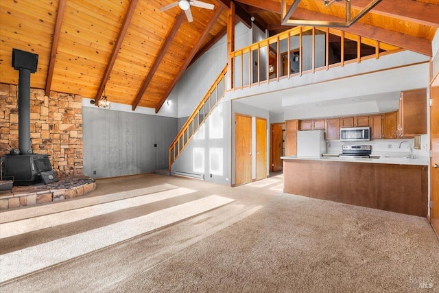 unfurnished living room featuring a baseboard heating unit, beam ceiling, sink, wood ceiling, and high vaulted ceiling