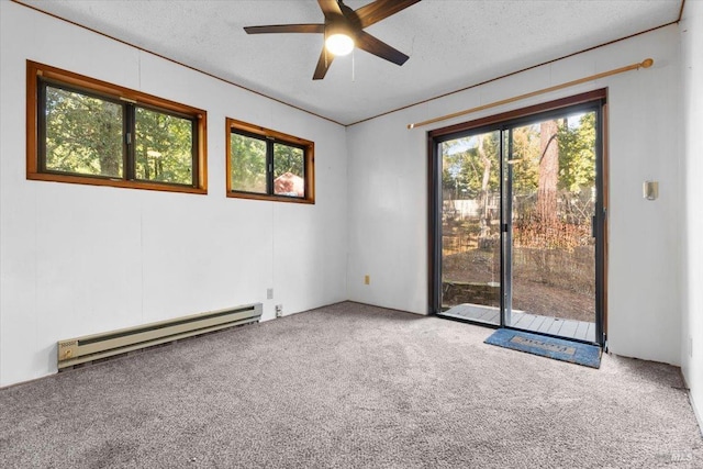 spare room with ceiling fan, baseboard heating, a textured ceiling, and carpet flooring