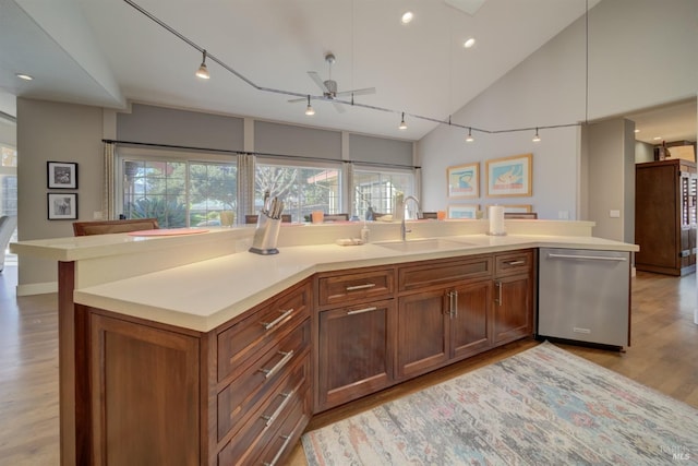 kitchen with sink, a center island with sink, and stainless steel dishwasher