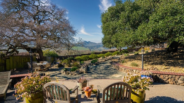 exterior space featuring a mountain view and a patio area