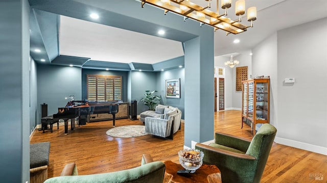 living room featuring an inviting chandelier and hardwood / wood-style flooring