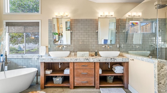 bathroom with decorative backsplash, shower with separate bathtub, and vanity