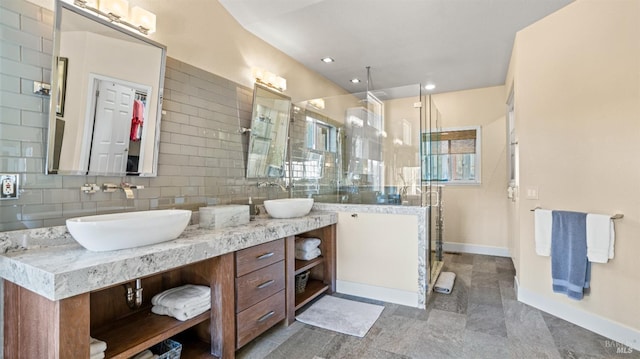 bathroom featuring tasteful backsplash, walk in shower, and vanity