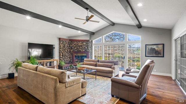 living room with ceiling fan, dark hardwood / wood-style flooring, lofted ceiling with beams, and a fireplace