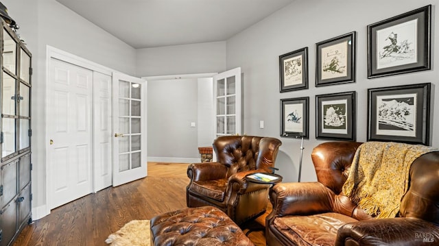 living area with dark wood-type flooring and french doors