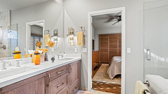 bathroom featuring an enclosed shower, ceiling fan, and vanity