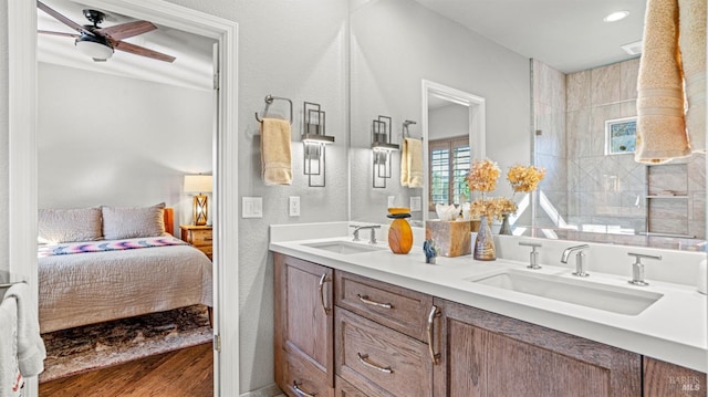 bathroom with vanity, ceiling fan, walk in shower, and hardwood / wood-style floors