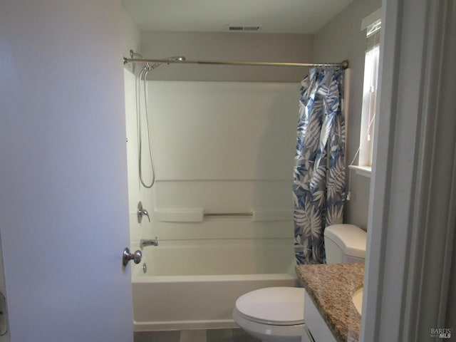 full bathroom with toilet, vanity, and shower / bath combo with shower curtain