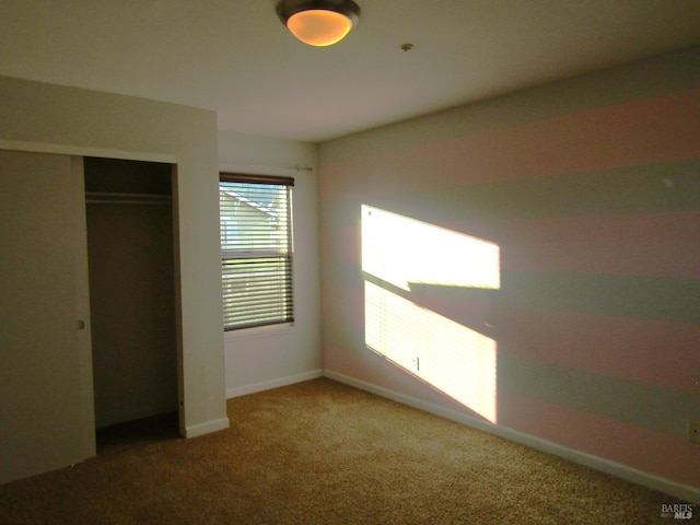 unfurnished bedroom featuring a closet and carpet flooring