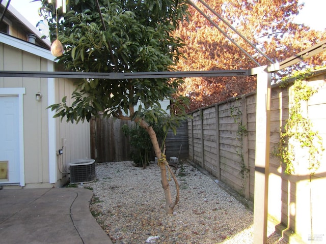 view of yard featuring central AC unit and a patio area