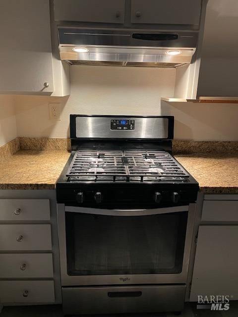 kitchen featuring stainless steel range with gas stovetop and gray cabinets