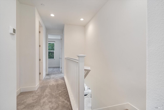 hallway featuring light carpet