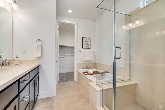 bathroom featuring tile patterned floors, separate shower and tub, and vanity