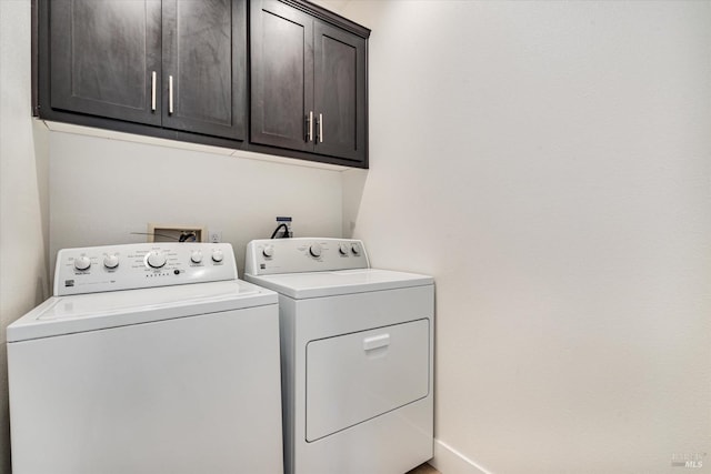 washroom with cabinets and independent washer and dryer