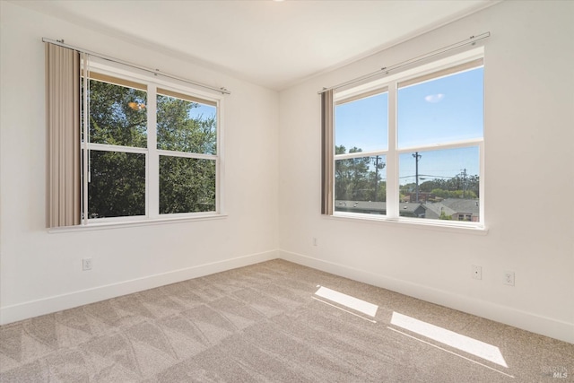 carpeted empty room with a wealth of natural light