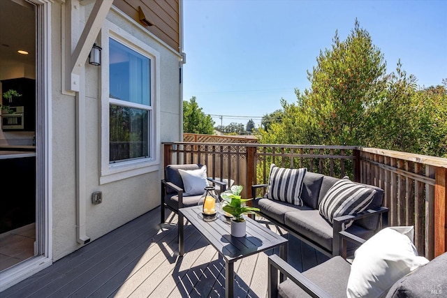 wooden balcony with an outdoor living space and a wooden deck