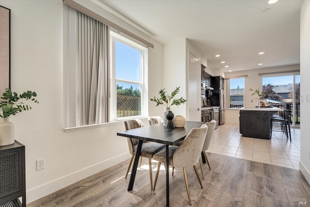 dining space featuring light wood-type flooring