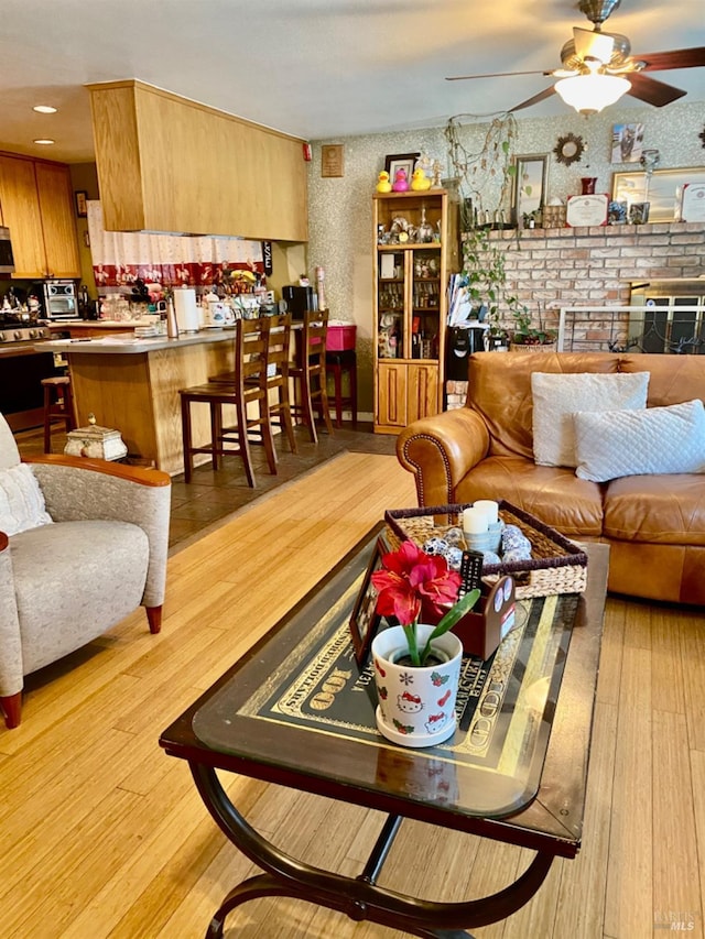 living room featuring wood finished floors and a ceiling fan