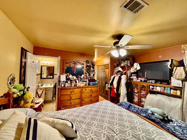 bedroom with ensuite bath, a ceiling fan, and visible vents