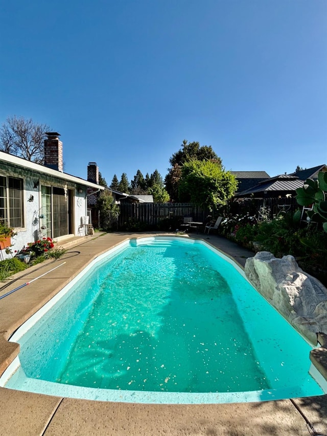 view of pool with a fenced backyard and a fenced in pool