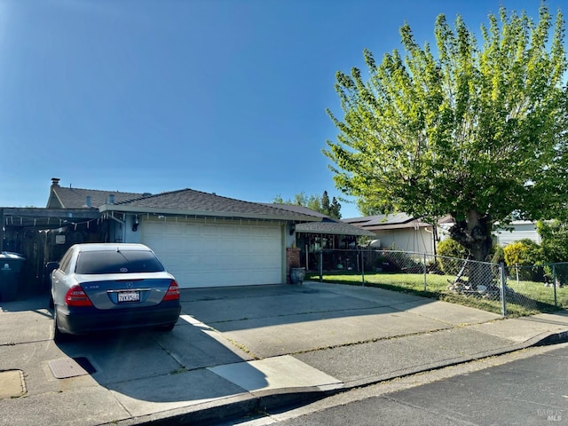 single story home featuring fence, concrete driveway, and a garage