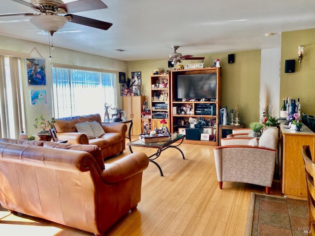 living area featuring wood finished floors and a ceiling fan