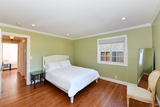 bedroom with ornamental molding and wood-type flooring