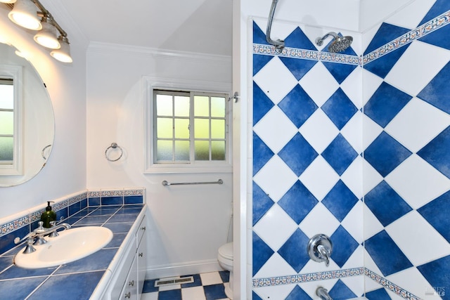 bathroom with toilet, vanity, a shower, and crown molding