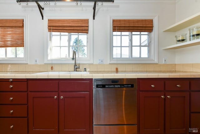 kitchen featuring sink, dishwasher, and tile countertops