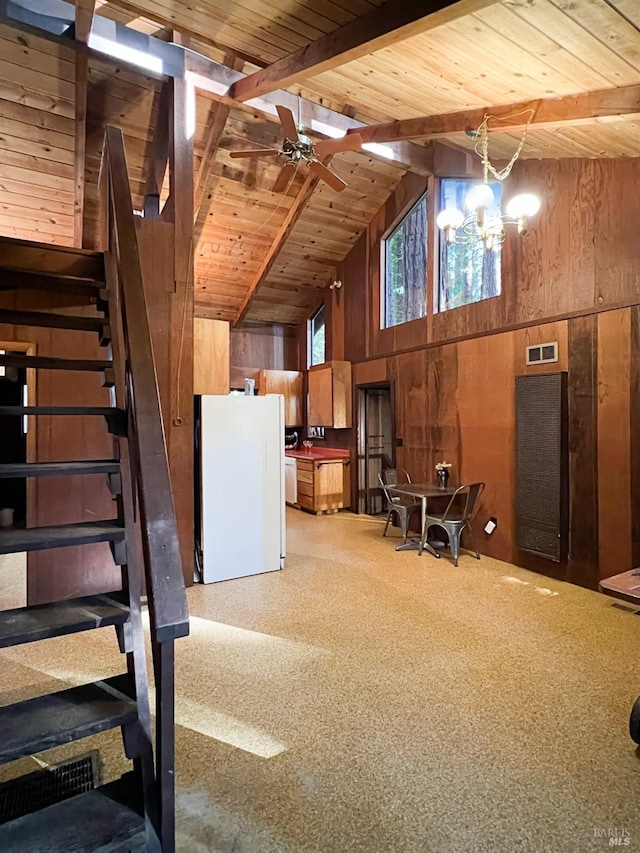 basement with ceiling fan with notable chandelier, wood ceiling, wooden walls, and white refrigerator