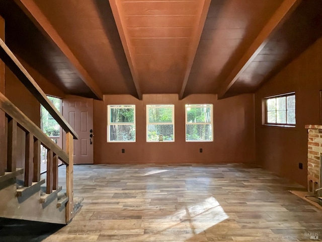 interior space featuring wooden ceiling, light hardwood / wood-style flooring, and vaulted ceiling with beams