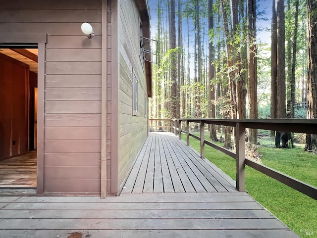 wooden deck featuring a yard