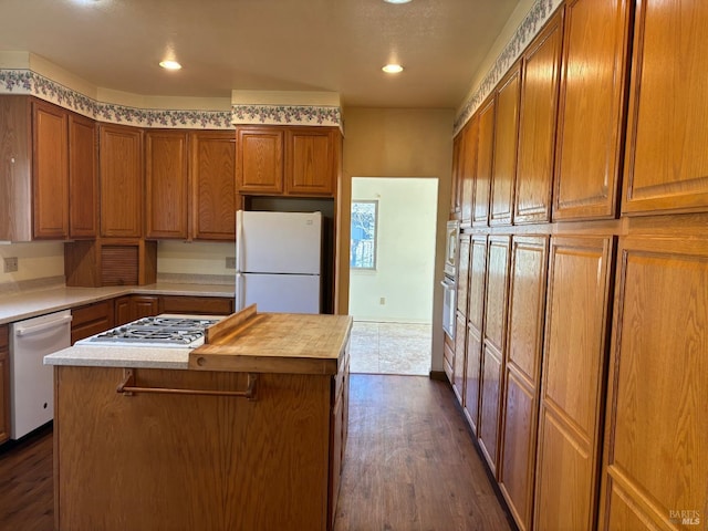 kitchen featuring dark wood-type flooring, appliances with stainless steel finishes, and a kitchen island