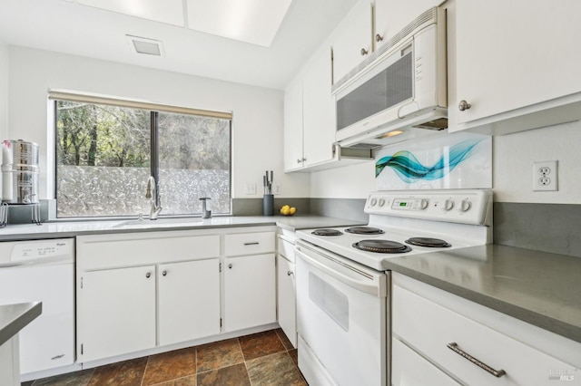 kitchen with sink, white appliances, and white cabinets