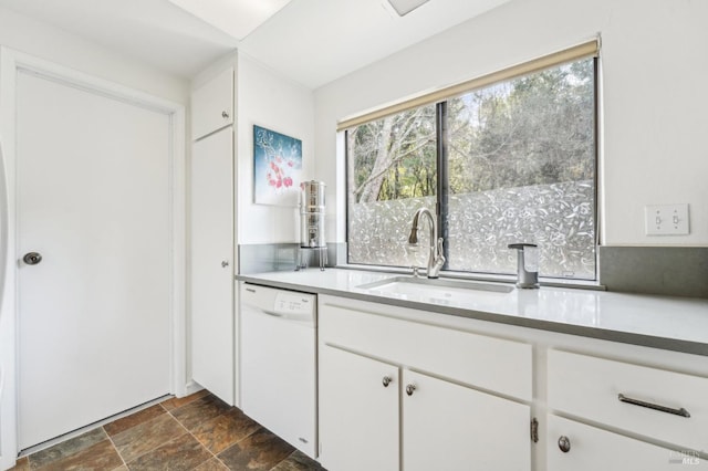 kitchen with white dishwasher, sink, and white cabinetry