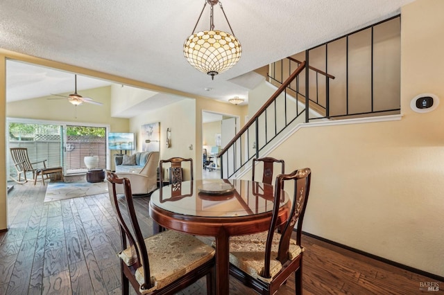 dining room with dark wood-type flooring, a textured ceiling, vaulted ceiling, and ceiling fan