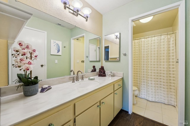 bathroom featuring vanity, hardwood / wood-style floors, and toilet