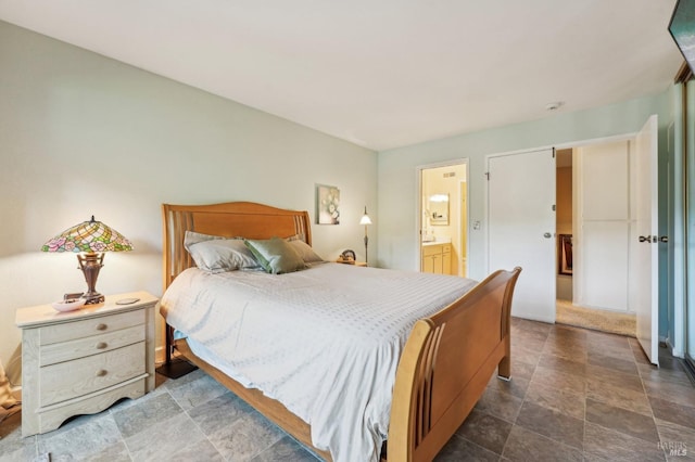 bedroom with ensuite bathroom and a barn door