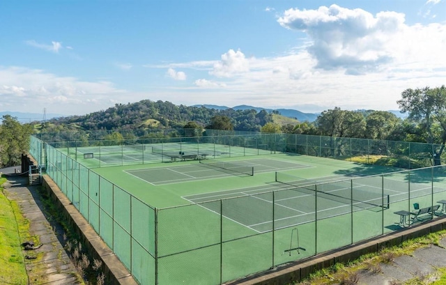 view of tennis court featuring a mountain view