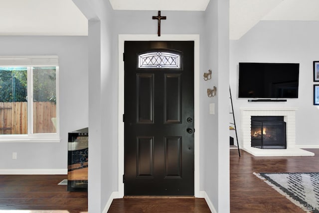 entryway featuring a fireplace and dark wood-type flooring