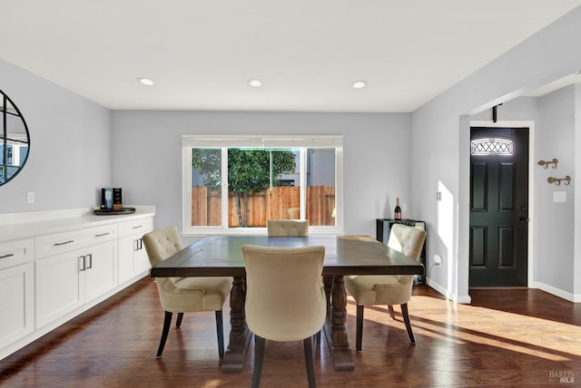 dining space with dark hardwood / wood-style flooring