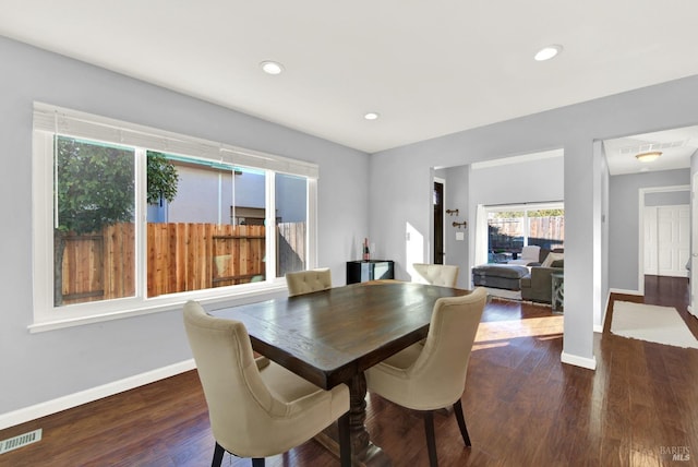 dining space with dark hardwood / wood-style floors