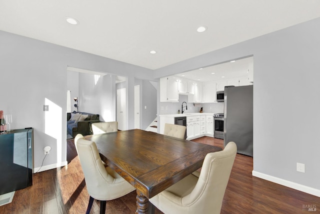 dining room with dark hardwood / wood-style flooring